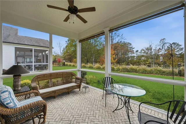 a view of a patio with a table chairs and a yard