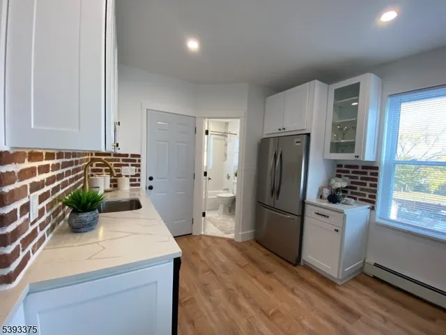 a kitchen with a refrigerator and a sink