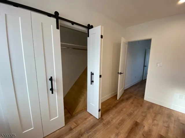 a view of entryway with wooden floor and cabinet