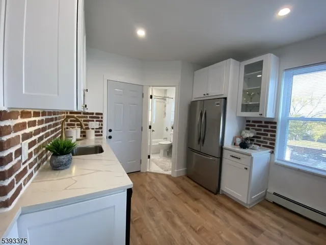 a kitchen with a refrigerator and a sink