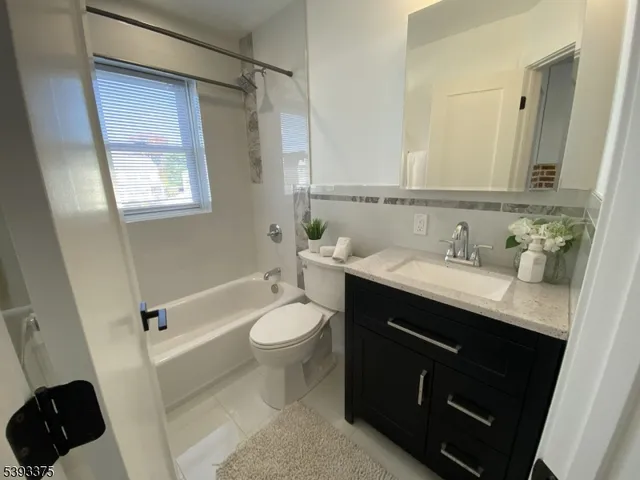 a bathroom with a sink a toilet a shower and a mirror