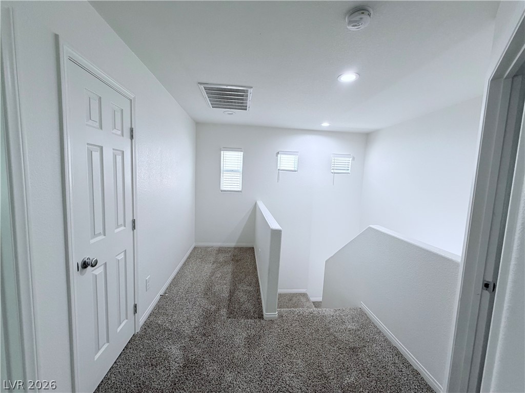 3610 Wireless Court Las Vegas, NV 89129 - Photo 6 of 15 A well-lit landing and staircase provide a welcoming transition between floors.