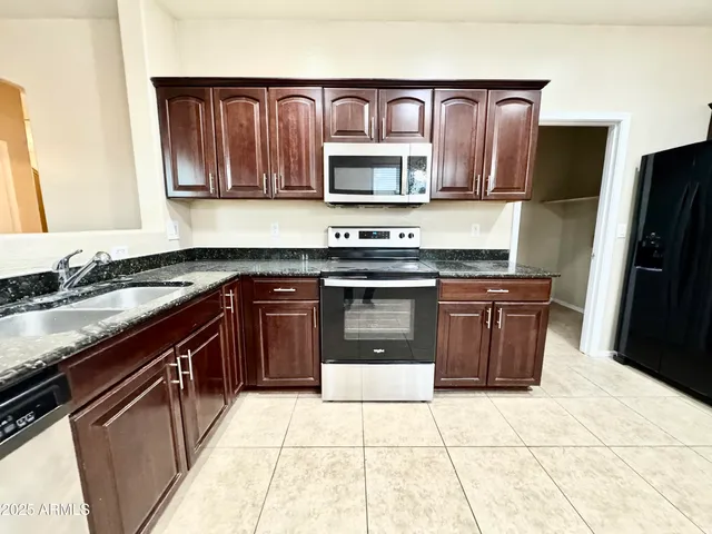 a view of kitchen appliances with wooden floor