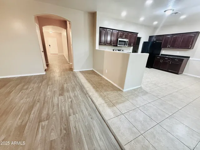 a view of a room with wooden floor and entryway