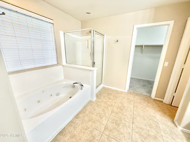 a bathroom with a tub shower and a sink