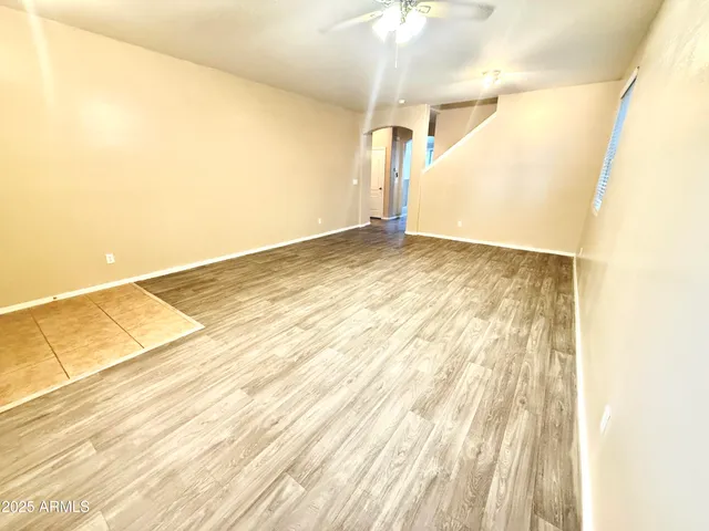a living room with furniture and a painting on the wall