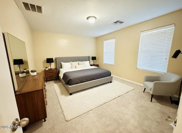 a bedroom with a bed and a couch