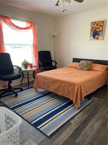 a bedroom with bed and window