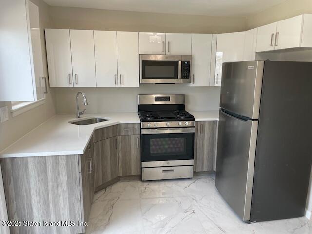 941 Willowbrook Road, Unit 2 Staten Island, NY 10314 - Photo 1 of 5 a kitchen with a refrigerator sink and microwave