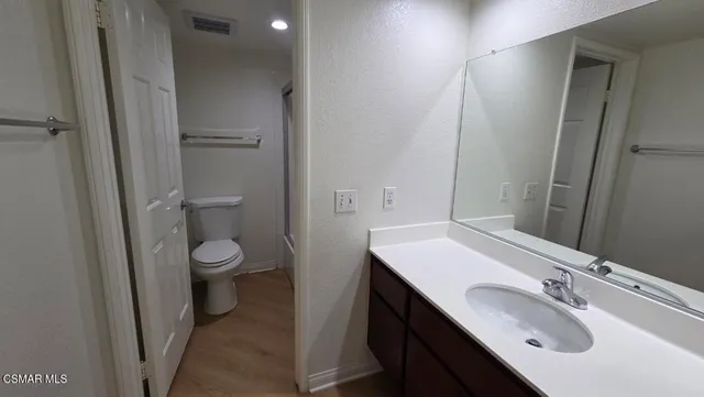 a bathroom with a sink toilet and vanity