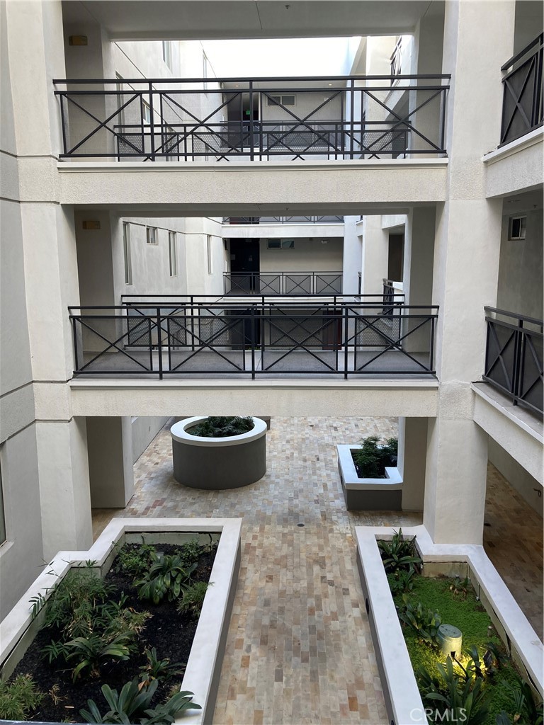 712 East Walnut Street, Unit 306 Pasadena, CA 91101 - Photo 2 of 8 a view of a patio with table and chairs potted plants