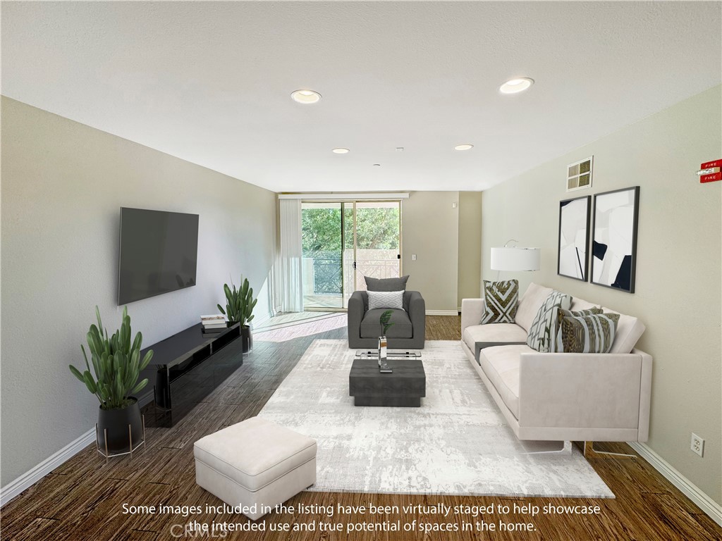 712 East Walnut Street, Unit 306 Pasadena, CA 91101 - Photo 3 of 8 a living room with furniture wooden floor and a flat screen tv