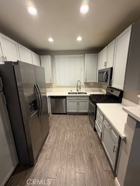 712 East Walnut Street, Unit 306 Pasadena, CA 91101 - Photo 6 of 8 a kitchen with a sink a refrigerator and cabinets