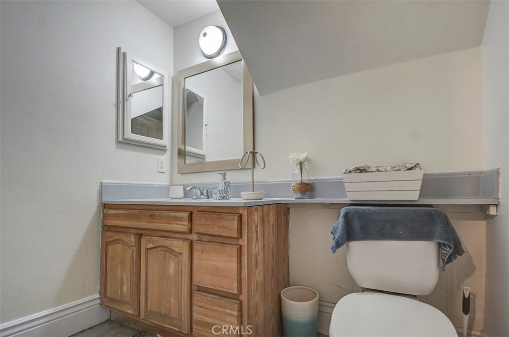 2119 West Edinger Avenue, Unit A Santa Ana, CA 92704 - Photo 12 of 24 a bathroom with a toilet a sink and mirror