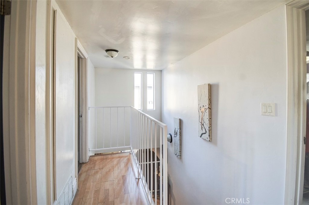 2119 West Edinger Avenue, Unit A Santa Ana, CA 92704 - Photo 15 of 24 a view of hallway with stairs and wooden floor