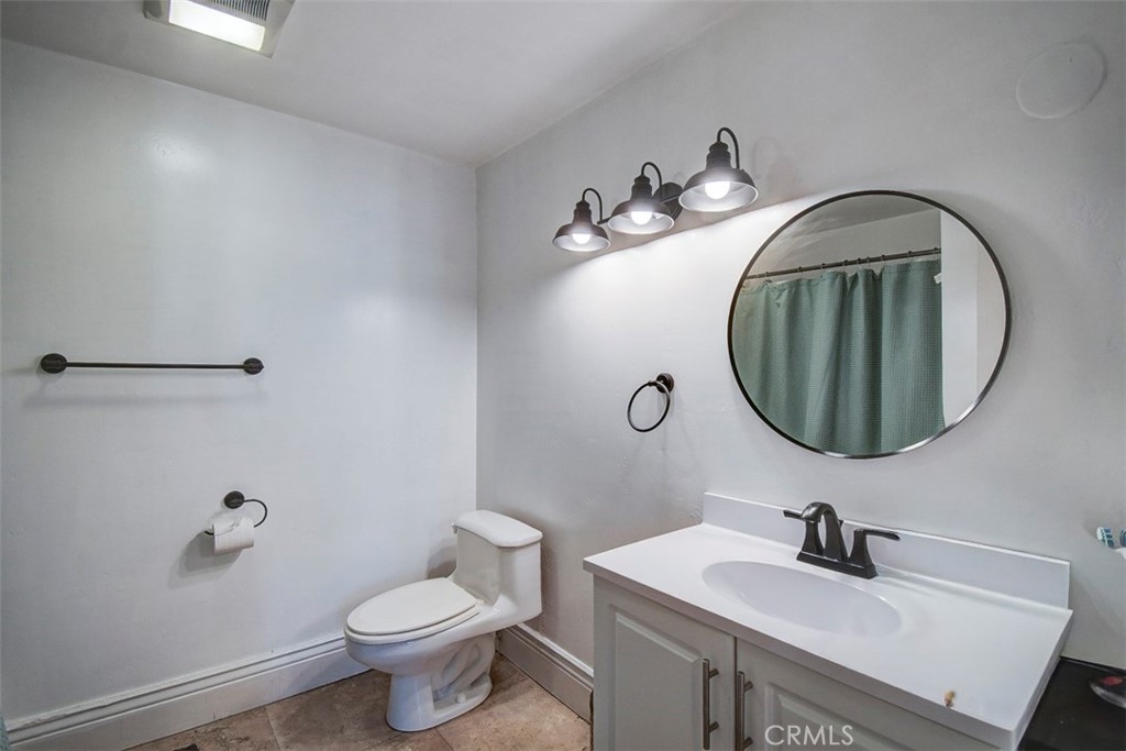 2119 West Edinger Avenue, Unit A Santa Ana, CA 92704 - Photo 16 of 24 a bathroom with a sink mirror and toilet
