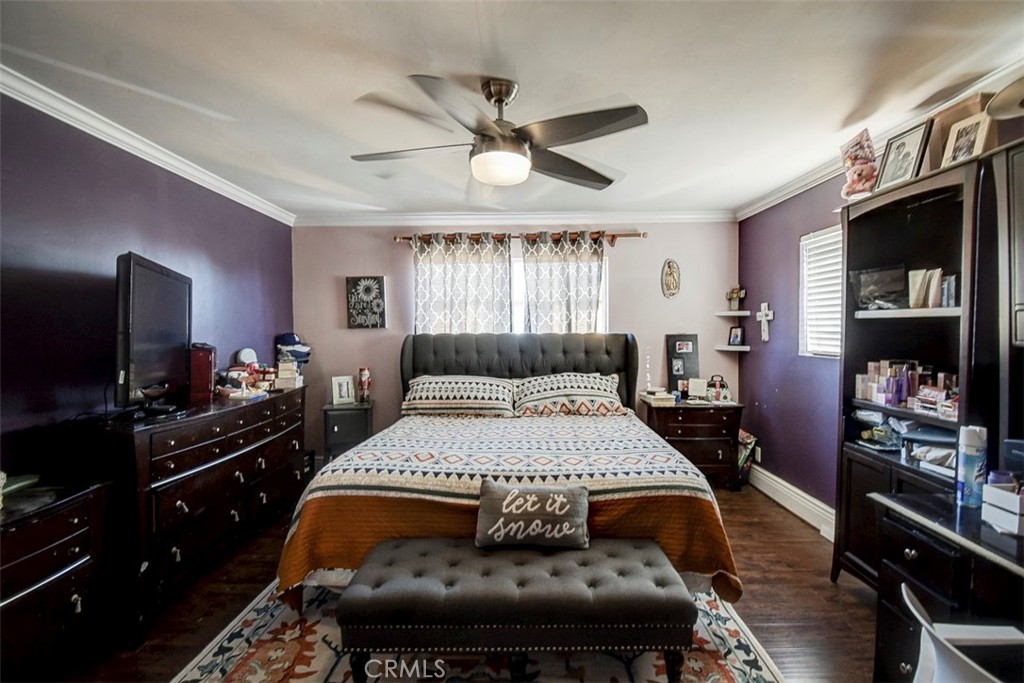 2119 West Edinger Avenue, Unit A Santa Ana, CA 92704 - Photo 19 of 24 a bedroom with a large bed and a flat tv screen on dresser