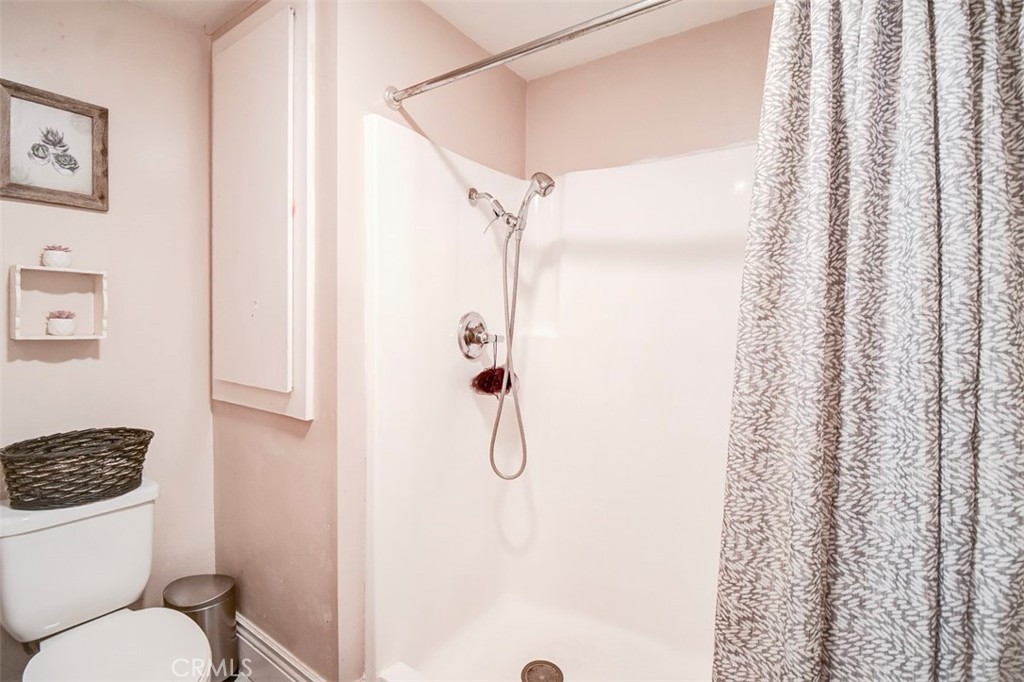2119 West Edinger Avenue, Unit A Santa Ana, CA 92704 - Photo 22 of 24 a bathroom with a toilet and shower
