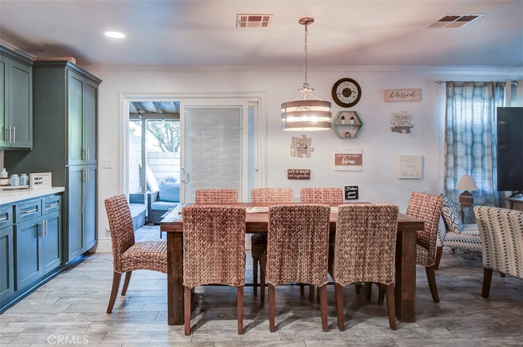 2119 West Edinger Avenue, Unit A Santa Ana, CA 92704 - Photo 8 of 24 a view of a dining room with furniture window and wooden floor