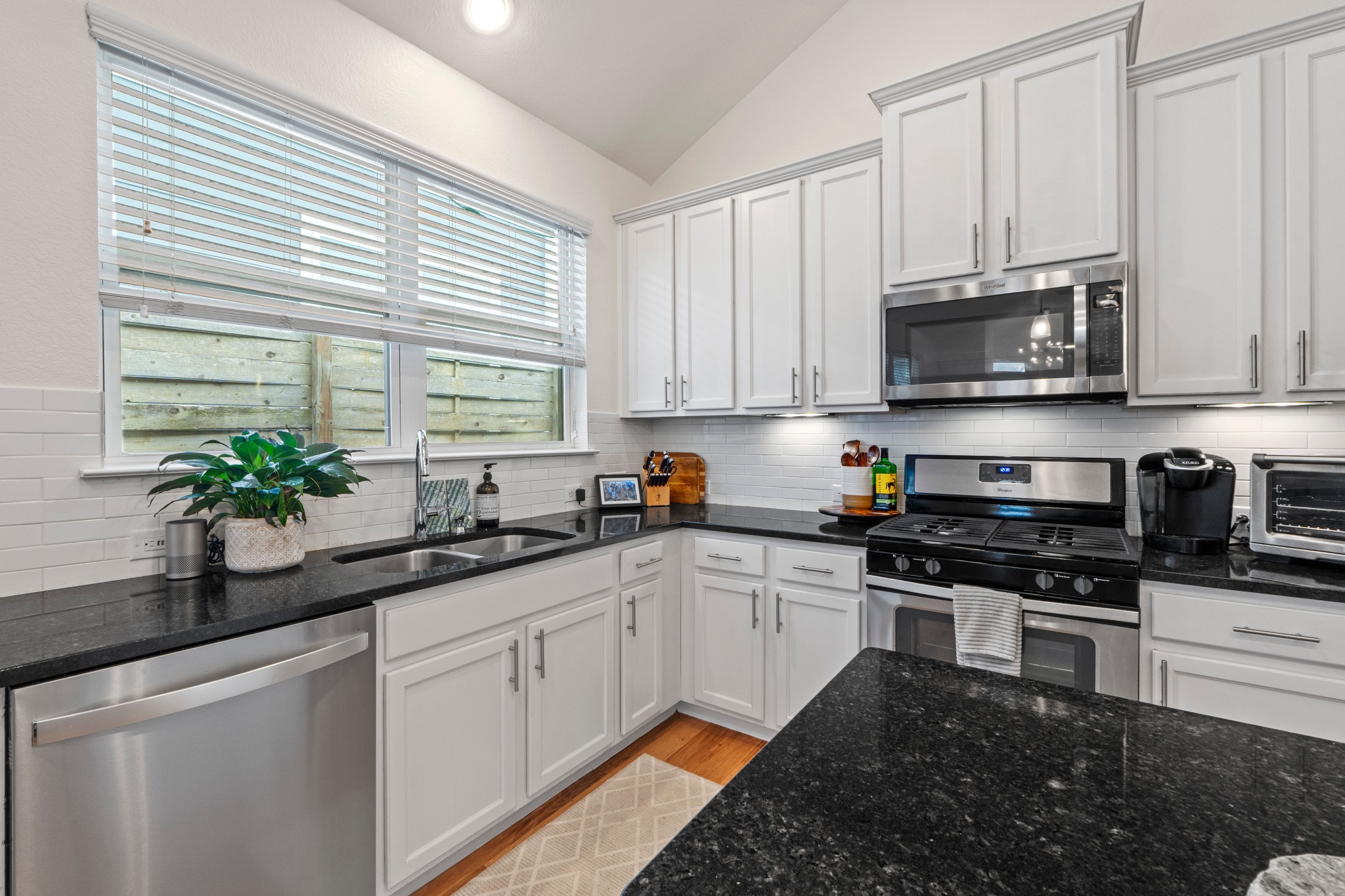 2100 Hermia Street, Unit 41 Austin, TX 78741 - Photo 7 of 22 a kitchen with granite countertop a sink stainless steel appliances and cabinets