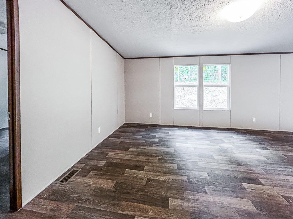 564 Ridge Road Dawsonville, GA 30534 - Photo 15 of 25 an empty room with wooden floor and windows