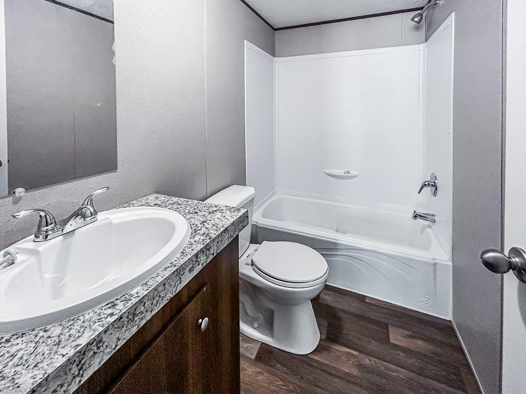 564 Ridge Road Dawsonville, GA 30534 - Photo 18 of 25 a bathroom with a granite countertop sink toilet and shower