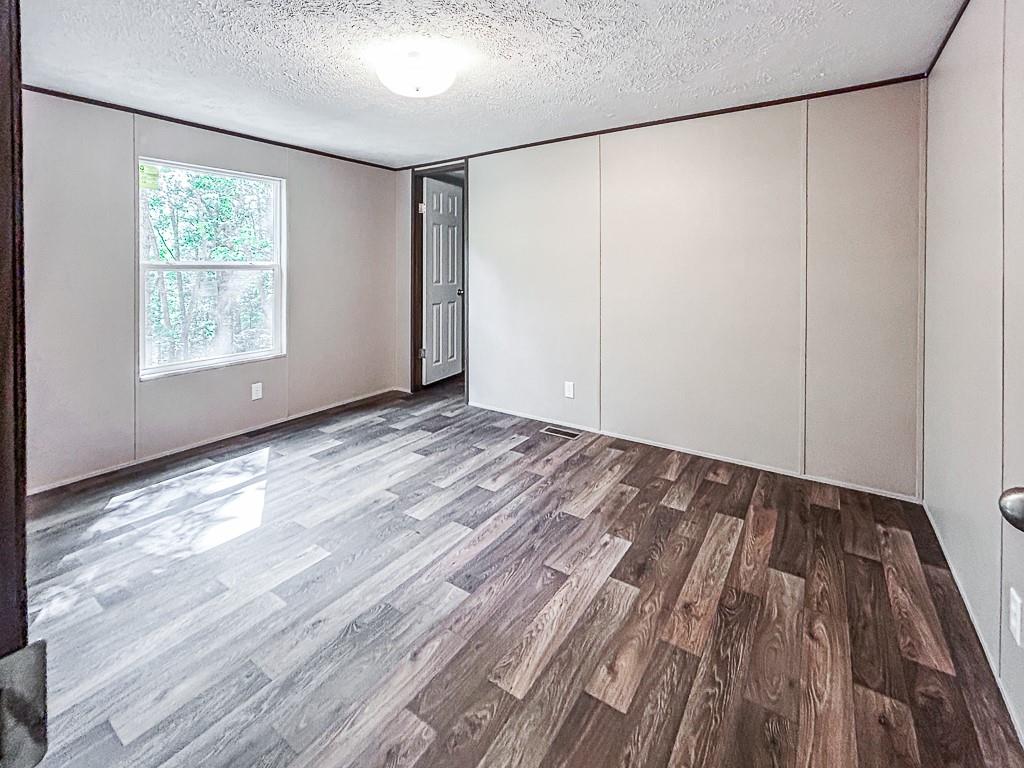 564 Ridge Road Dawsonville, GA 30534 - Photo 19 of 25 a view of an empty room with wooden floor and a window