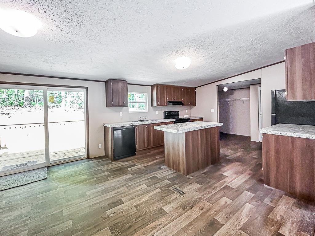 564 Ridge Road Dawsonville, GA 30534 - Photo 21 of 25 a kitchen with stainless steel appliances a stove top oven a sink a refrigerator a window
