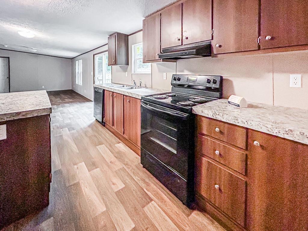 564 Ridge Road Dawsonville, GA 30534 - Photo 5 of 25 a kitchen with stainless steel appliances granite countertop a stove a sink dishwasher and cabinets with wooden floor