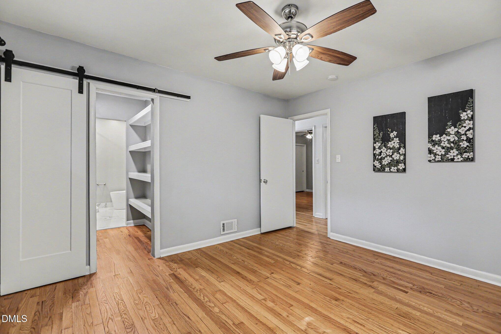 2600 Wade Avenue Raleigh, NC 27607 - Photo 14 of 31 an empty room with wooden floor and a ceiling fan