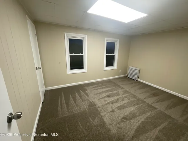 a view of a house with a yard and wooden fence