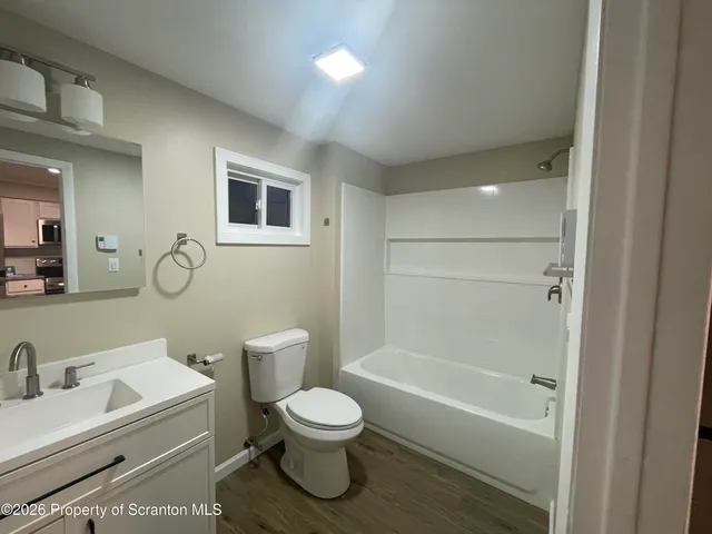 a white toilet sitting next to a bathroom sink
