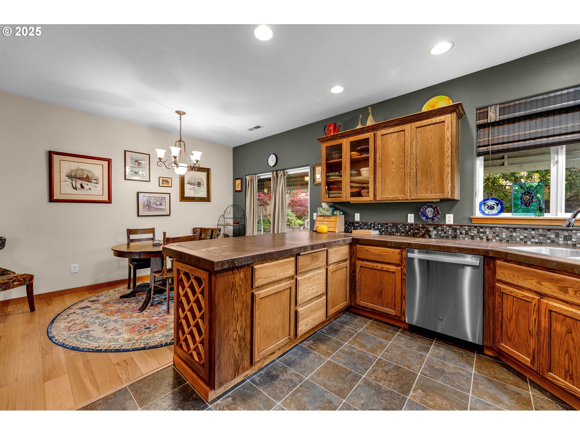 1035 East Pioneer Loop La Center, WA 98629 - Photo 11 of 43 a kitchen with stainless steel appliances kitchen island granite countertop a sink cabinets and window
