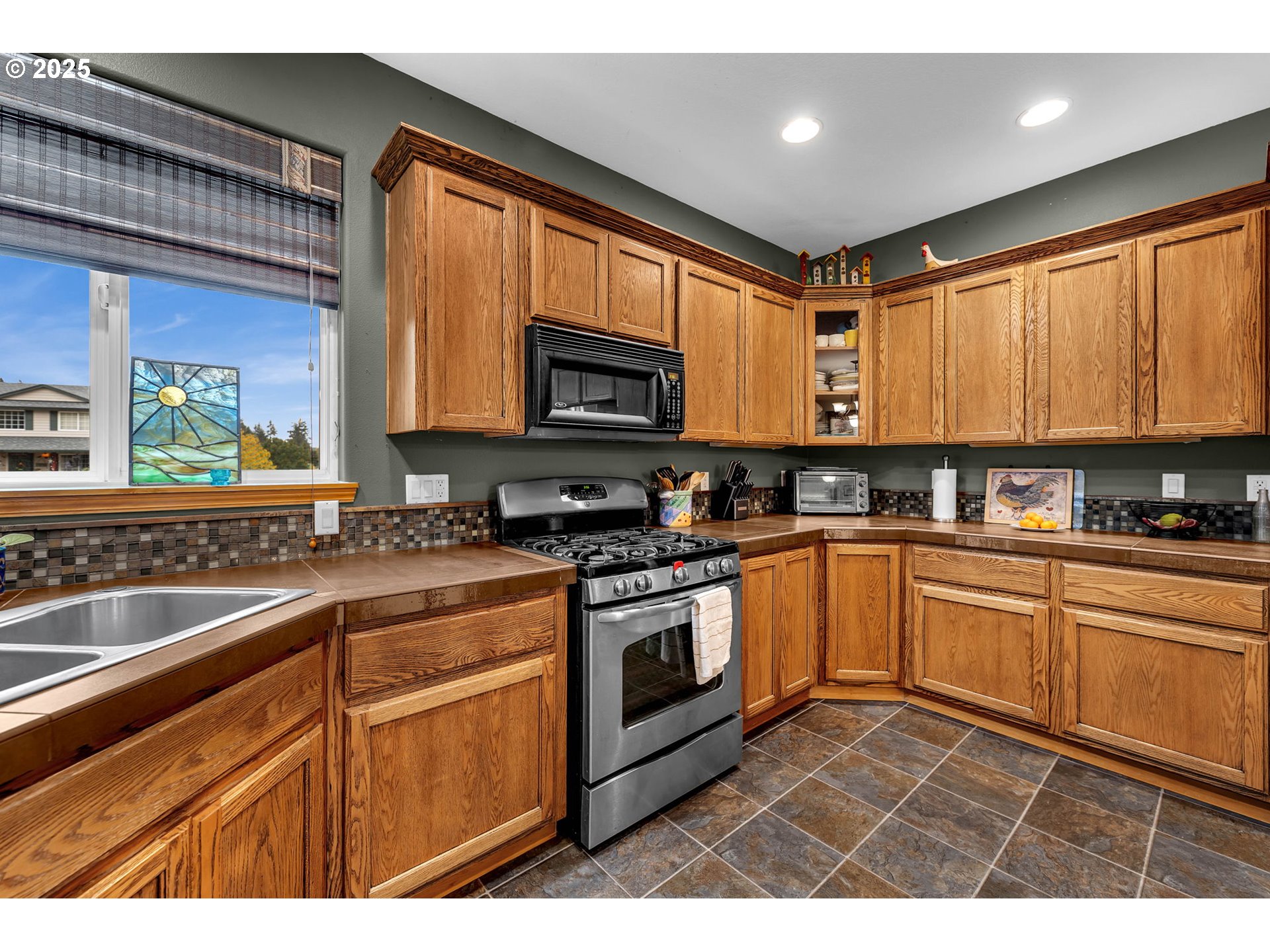 1035 East Pioneer Loop La Center, WA 98629 - Photo 12 of 43 a kitchen with granite countertop stainless steel appliances a stove sink and microwave