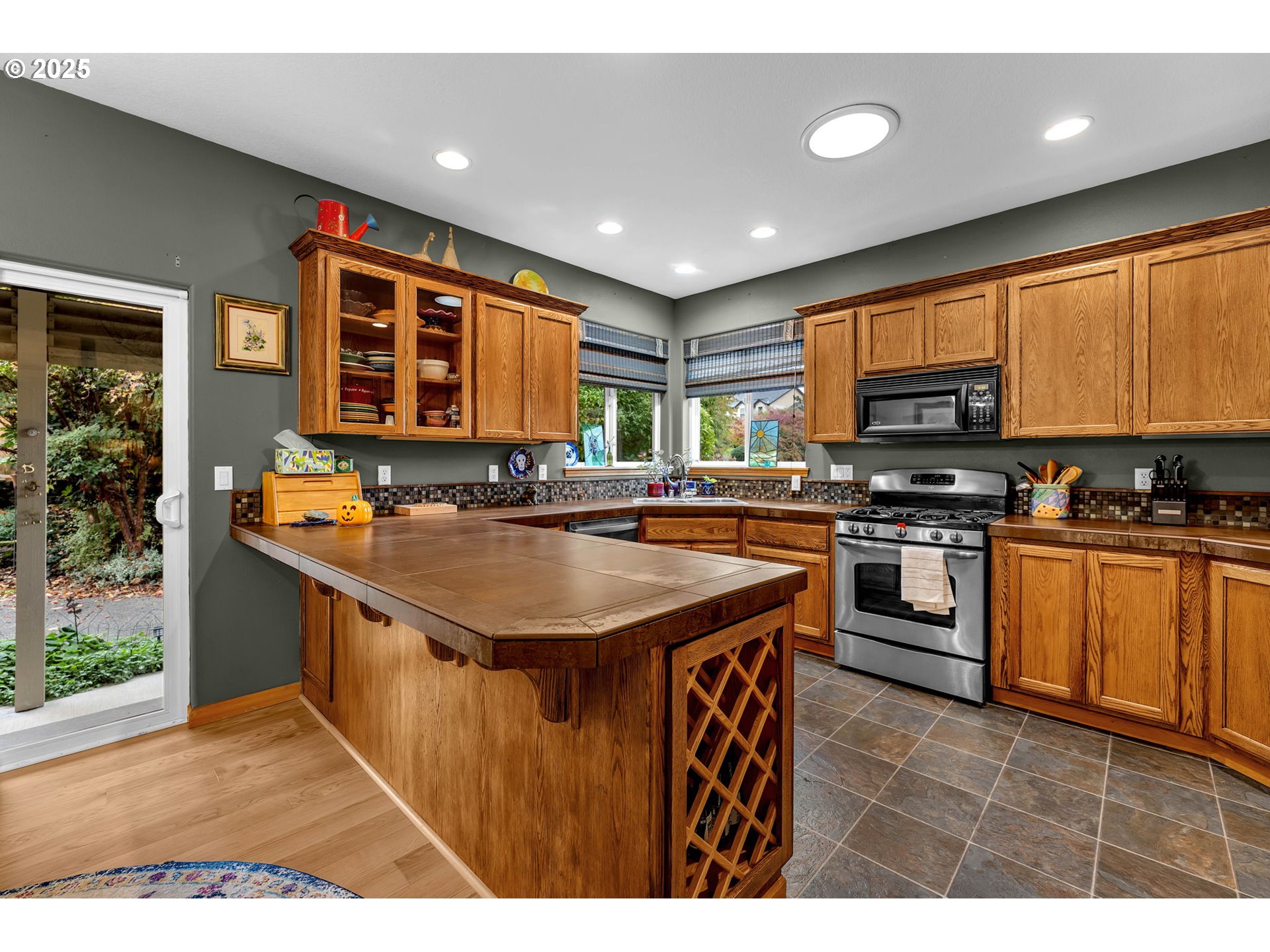1035 East Pioneer Loop La Center, WA 98629 - Photo 9 of 43 a kitchen with stainless steel appliances granite countertop a stove a sink and a microwave