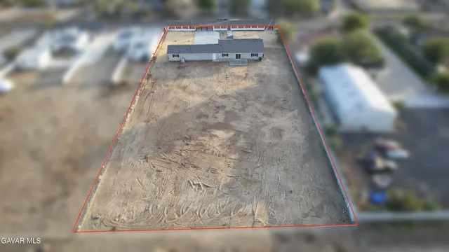 a view of an empty room and a kitchen