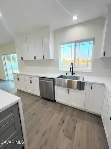 a bathroom with a toilet mirror vanity and sink