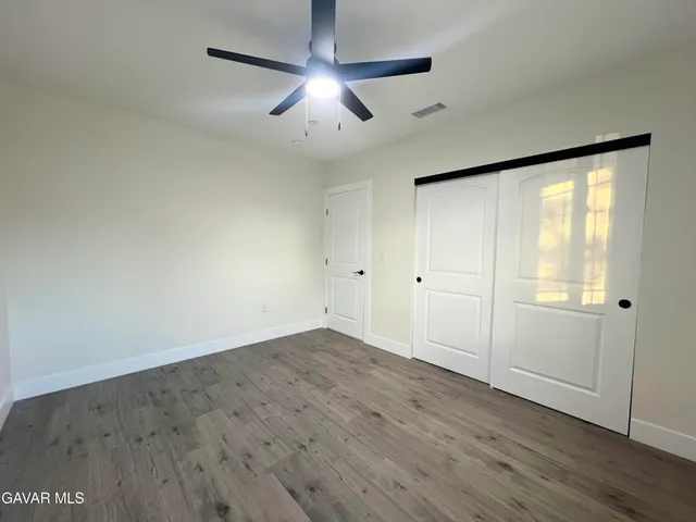 a bathroom with a toilet a sink a mirror a bathtub and vanity