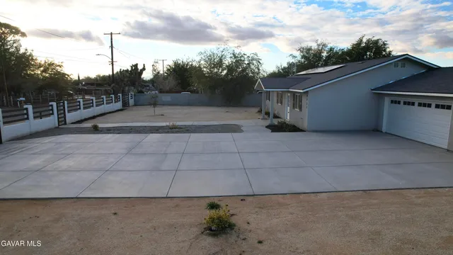 a view of a house with a wooden deck
