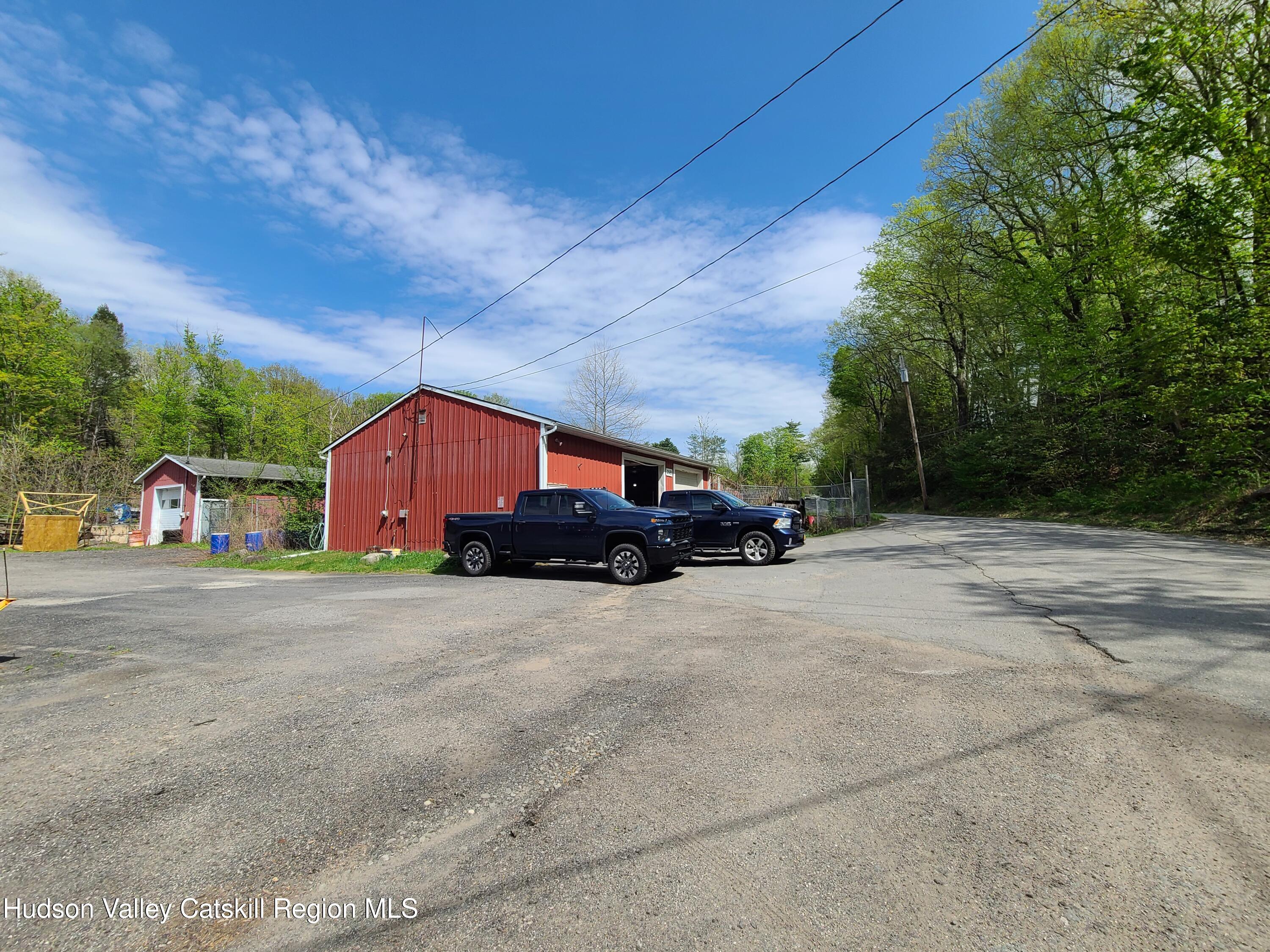 26-48 Hook Road Sparrow Bush, NY 12780 - Photo 22 of 32 a front view of a house with a yard and garage
