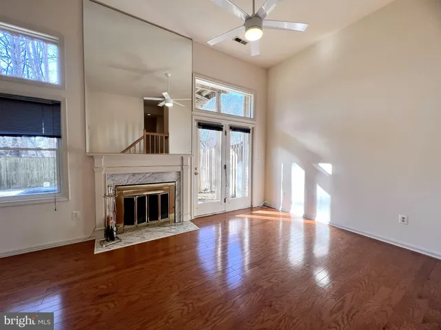 a view of empty room with wooden floor and fireplace