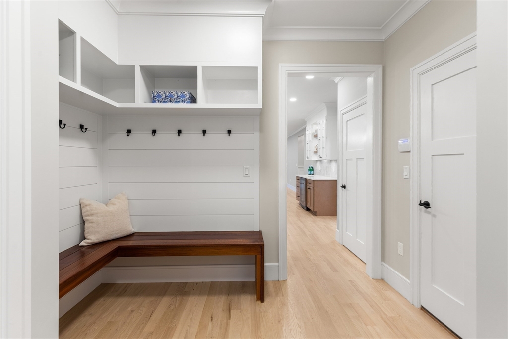 12 Pleasant Street Burlington, MA 01803 - Photo 11 of 30 a view of a hallway with wooden floor and staircase