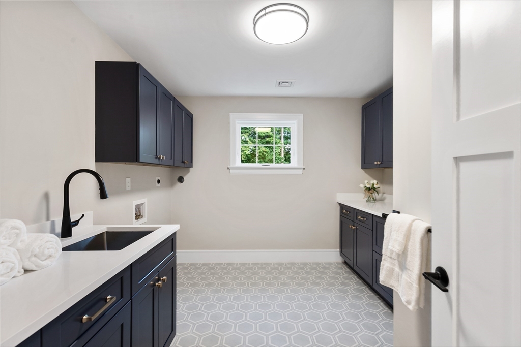 12 Pleasant Street Burlington, MA 01803 - Photo 20 of 30 a kitchen with a sink cabinets and a window