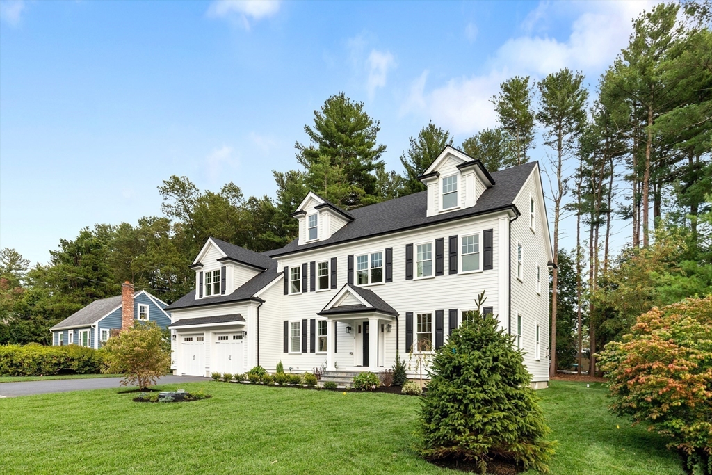 12 Pleasant Street Burlington, MA 01803 - Photo 2 of 30 a front view of a house with a garden and plants
