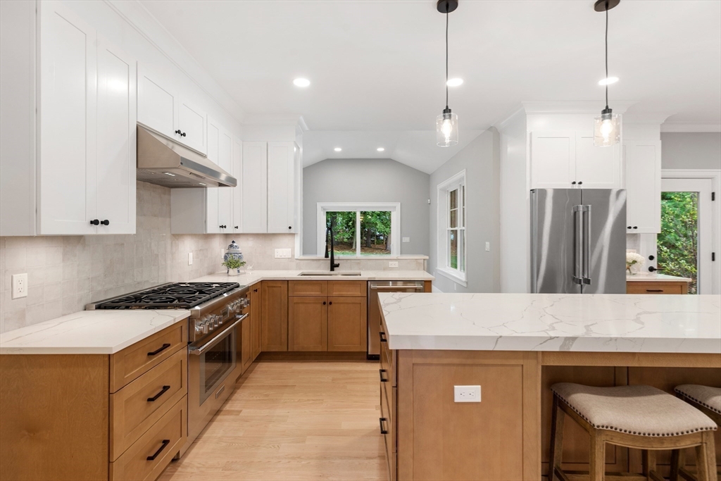 12 Pleasant Street Burlington, MA 01803 - Photo 10 of 30 a kitchen with stainless steel appliances granite countertop a sink stove and refrigerator