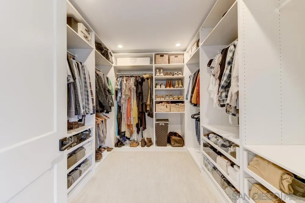 9944 Connell Road San Diego, CA 92131 - Photo 13 of 25 a view of walk in closet with clothes and shoes