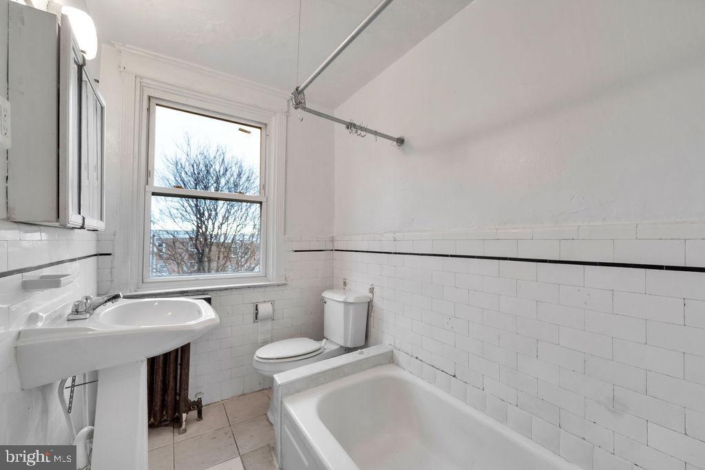 6997 Guilford Road Upper Darby, PA 19082 - Photo 12 of 17 a bathroom with a sink and a bathtub