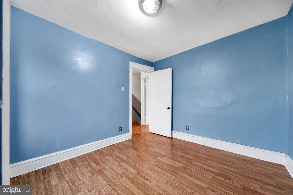 6997 Guilford Road Upper Darby, PA 19082 - Photo 14 of 17 a view of an empty room with wooden floor