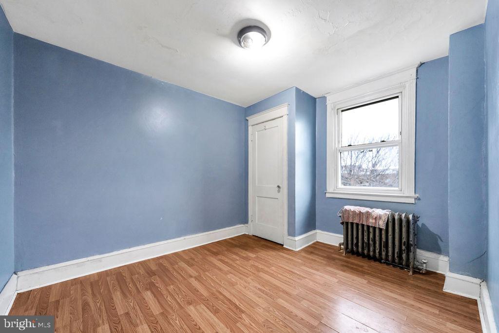 6997 Guilford Road Upper Darby, PA 19082 - Photo 15 of 17 an empty room with wooden floor and windows