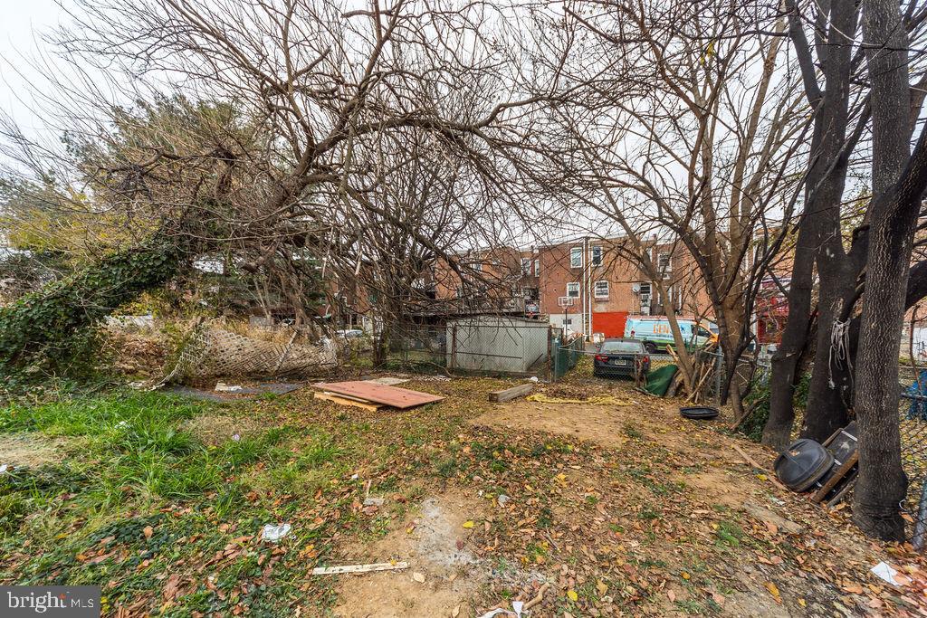 6997 Guilford Road Upper Darby, PA 19082 - Photo 17 of 17 a view of backyard with wooden fence and large trees